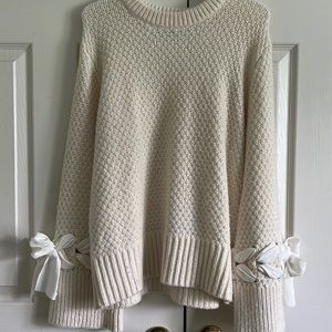 Club Monaco cream sweater with tie details on sleeves